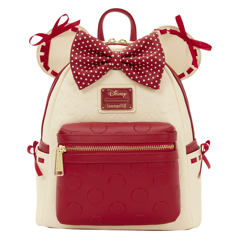 Front view of the Loungefly Disney Minnie Mouse Rocks The Dots mini backpack with red polka dot bow, Minnie ears and red front zip pocket.