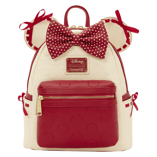 Front view of the Loungefly Disney Minnie Mouse Rocks The Dots mini backpack with red polka dot bow, Minnie ears and red front zip pocket.