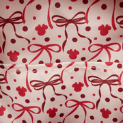 Close-up of the interior lining of the Loungefly Disney Minnie Mouse mini backpack with red bows, polka dots and Mickey icon silhouettes.