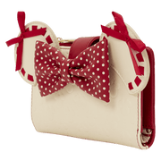 Angled view of the Loungefly Disney Minnie Rocks The Dots wallet showing Minnie ears, red polka dot bow and cream body with subtle embossed icons.
