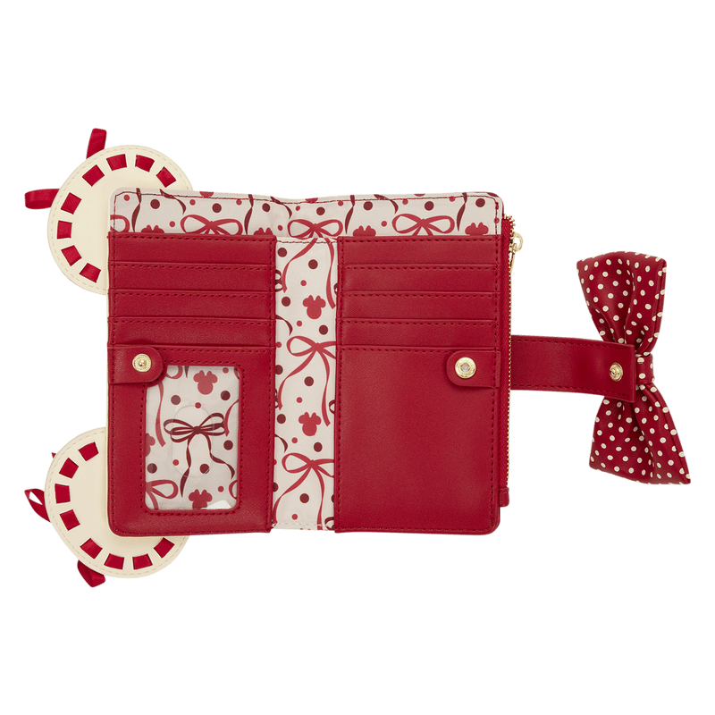 Open view of the Loungefly Disney Minnie Rocks The Dots wallet showing card slots, ID window and red bow and polka dot interior print.