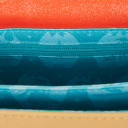 Interior lining of Loungefly Moana crossbody with ocean icons in teal fabric