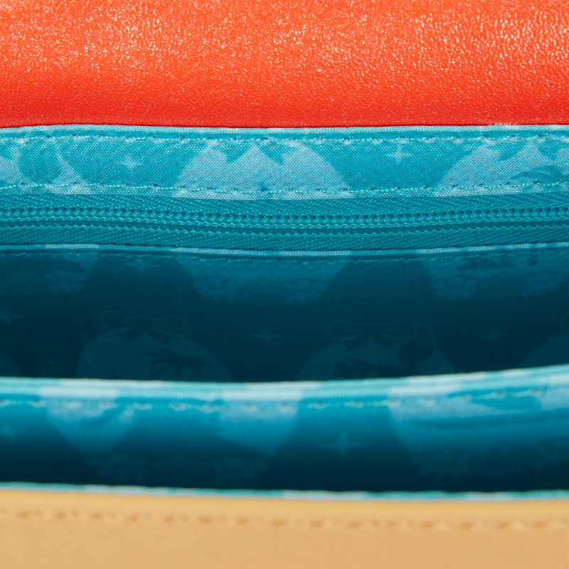 Interior lining of Loungefly Moana crossbody with ocean icons in teal fabric