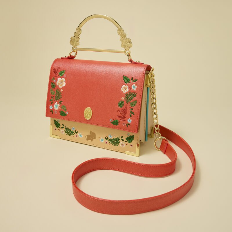 Studio shot of Loungefly Moana crossbody showing red strap, gold chain and floral trim