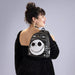 Model wearing Loungefly NBX sequin mini backpack with Jack Skellington face on front pocket.