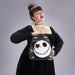 Model holding Loungefly NBX mini backpack with sequin Jack Skellington smile, studio shot.