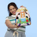 Model holding Loungefly Disney Pixar Toy Story backpack showing Jessie and Buzz Lightyear-inspired front