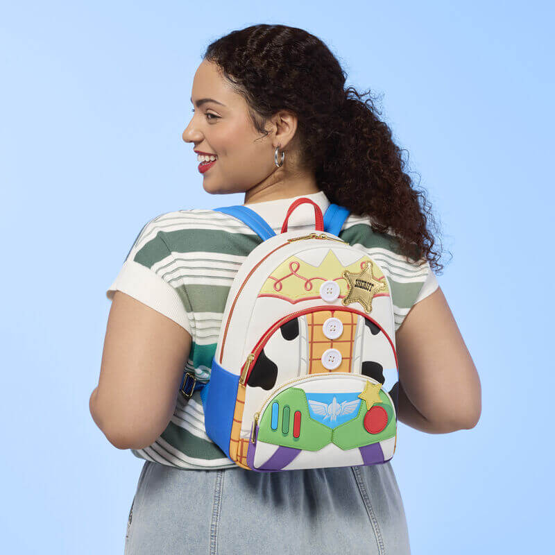 Model wearing Loungefly Disney Pixar Toy Story backpack with blue straps