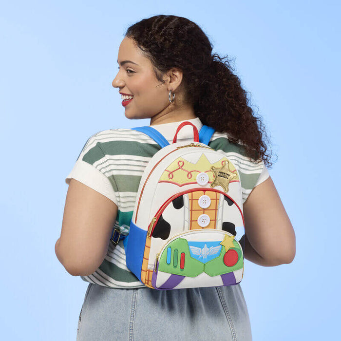Model wearing Loungefly Disney Pixar Toy Story backpack with blue straps