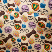 Close-up of the lining inside the Loungefly Disney Pixar Up 15th Anniversary Convertible Tote Bag with grape soda badges, balloons, bow ties and glasses print