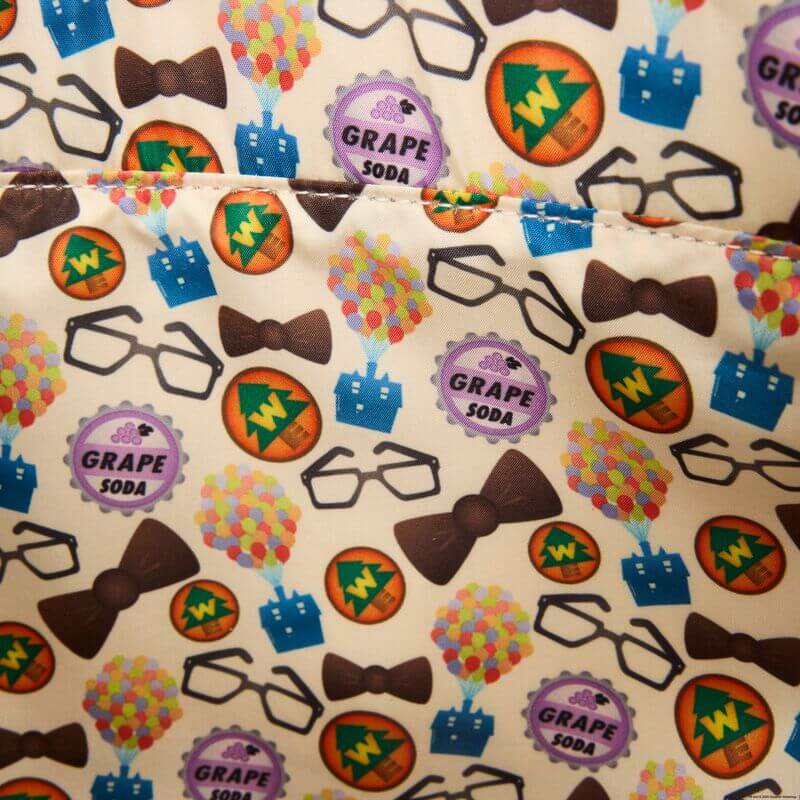 Close-up of the lining inside the Loungefly Disney Pixar Up 15th Anniversary Convertible Tote Bag with grape soda badges, balloons, bow ties and glasses print