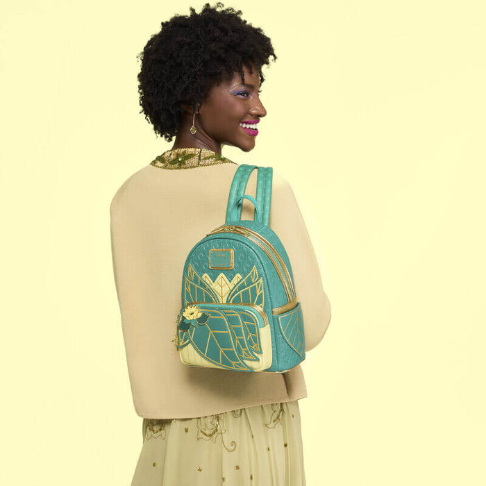 Lifestyle image of the Loungefly Disney The Princess and the Frog Tiana Cosplay Mini Backpack worn by a model