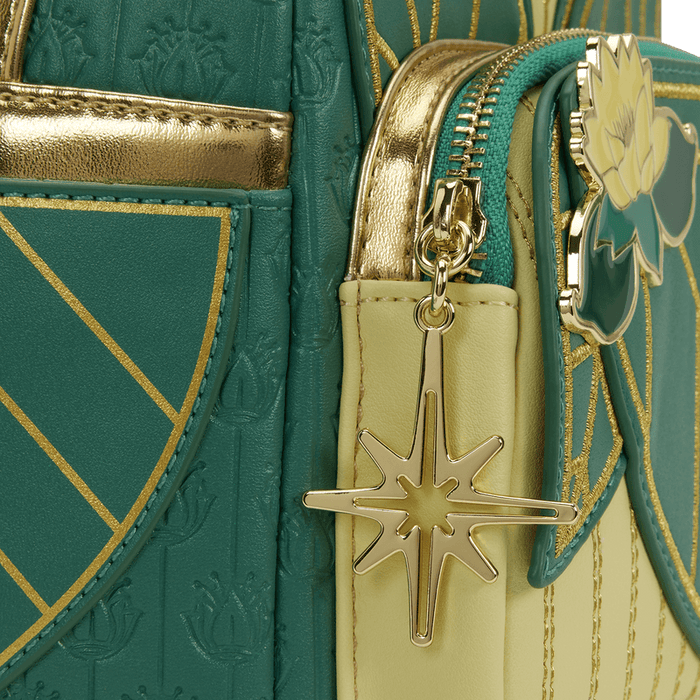Close-up of the gold star charm and lotus applique on the Loungefly Disney The Princess and the Frog Tiana Cosplay Mini Backpack