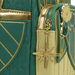 Close-up of the gold star charm and lotus applique on the Loungefly Disney The Princess and the Frog Tiana Cosplay Mini Backpack
