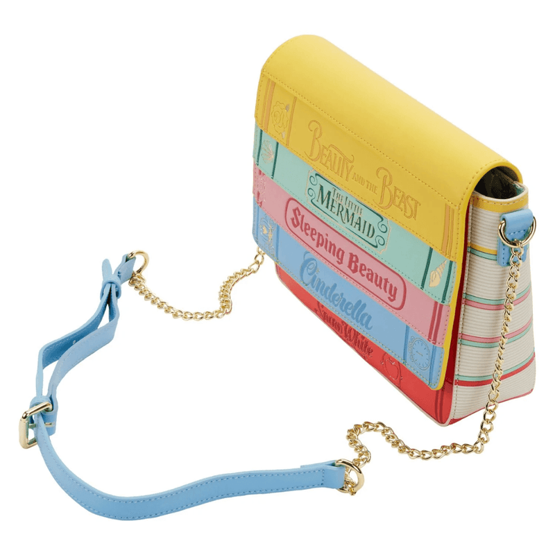 Angled view of the Loungefly Disney Princess Books crossbody bag with adjustable strap, gold chain detail and book-inspired front design