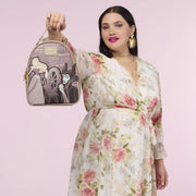 Lifestyle image of the Loungefly Disney Sleeping Beauty & Maleficent Spinning Wheel Mini Backpack held by a model