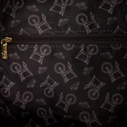 Close-up of the interior lining inside the Loungefly Disney Sleeping Beauty & Maleficent Spinning Wheel Mini Backpack with an all-over spinning wheel print