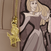 Close-up of the gold zipper charm on the Loungefly Disney Sleeping Beauty & Maleficent Spinning Wheel Mini Backpack featuring spinning wheel details