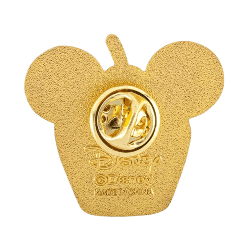 Reverse side of Disney snack enamel pin, gold-tone finish with textured crown pattern and Disney logo.

