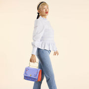 Model holding Loungefly Snow White crossbody by apple handle, full length