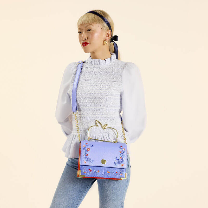 Model wearing Loungefly Snow White crossbody across body, apple handle visible
