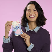 Model holding Loungefly Stitch and Angel Be Mine card holder in cream and pastel colours with Stitch heart applique