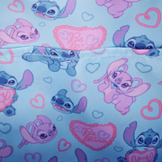 Close-up of printed lining with Stitch, Angel, hearts and Be Mine motifs inside the Loungefly mini backpack