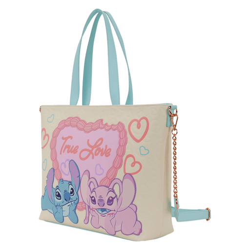 Angled view of the Loungefly Disney Stitch & Angel True Love tote bag showing light blue handles, detachable strap and gold chain detail.