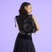 Model wearing the black Loungefly Disney Villains mini backpack showing embossed texture and round front panel