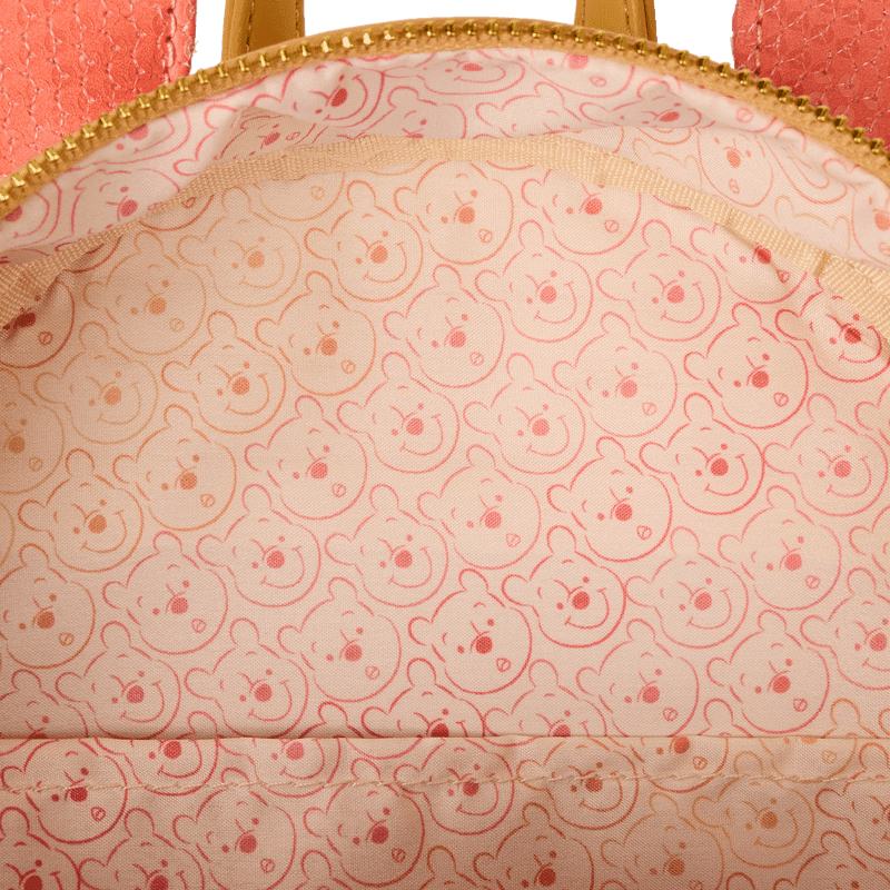 Close-up of Loungefly Disney Winnie the Pooh mini backpack lining with repeating Pooh face print