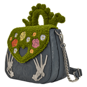 Angled view of the Loungefly Edward Scissorhands crossbody bag showing the chain strap, textured green flap and embossed gear pattern.