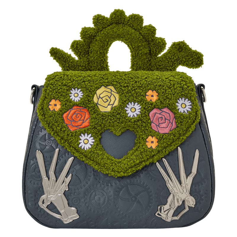 Front view of the Loungefly Edward Scissorhands crossbody bag with green textured flap, embroidered flowers, heart cut-out and silver scissorhand accents.