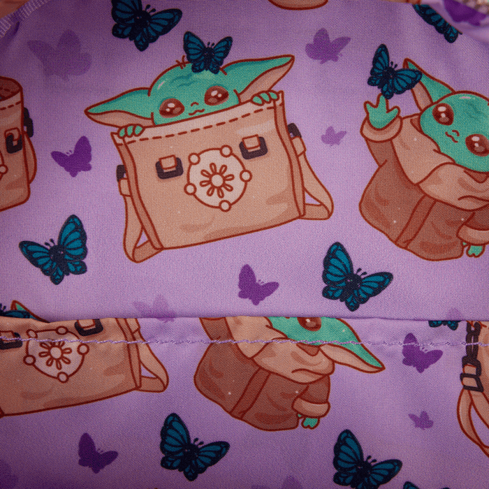 Close-up of the Loungefly Grogu backpack lining featuring Grogu and teal butterflies on purple fabric