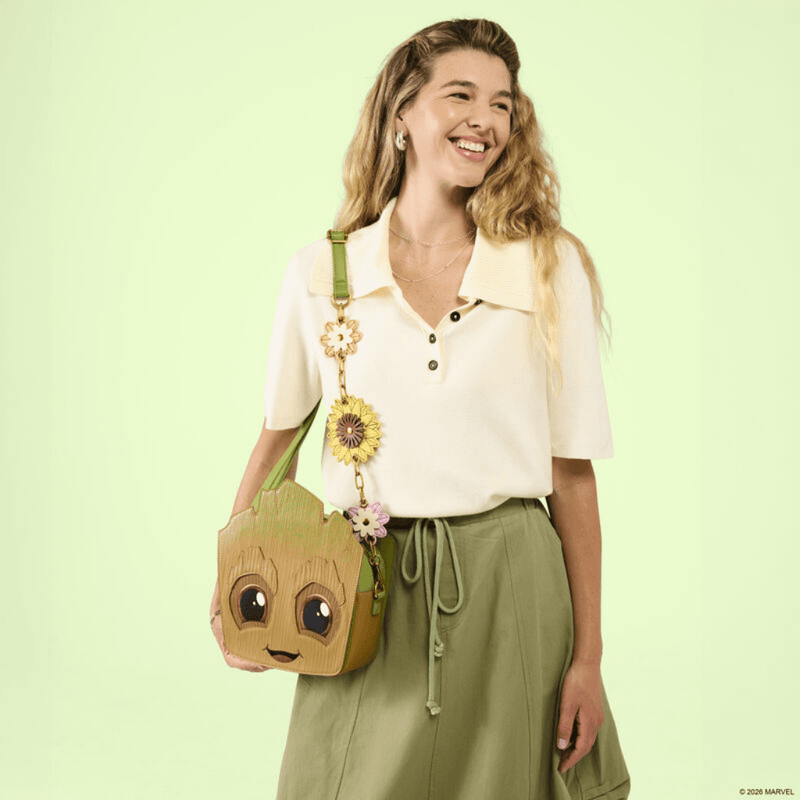 Model wearing the Loungefly Groot Spring Blooms Crossbody Bag with green adjustable strap and dangling flower charms