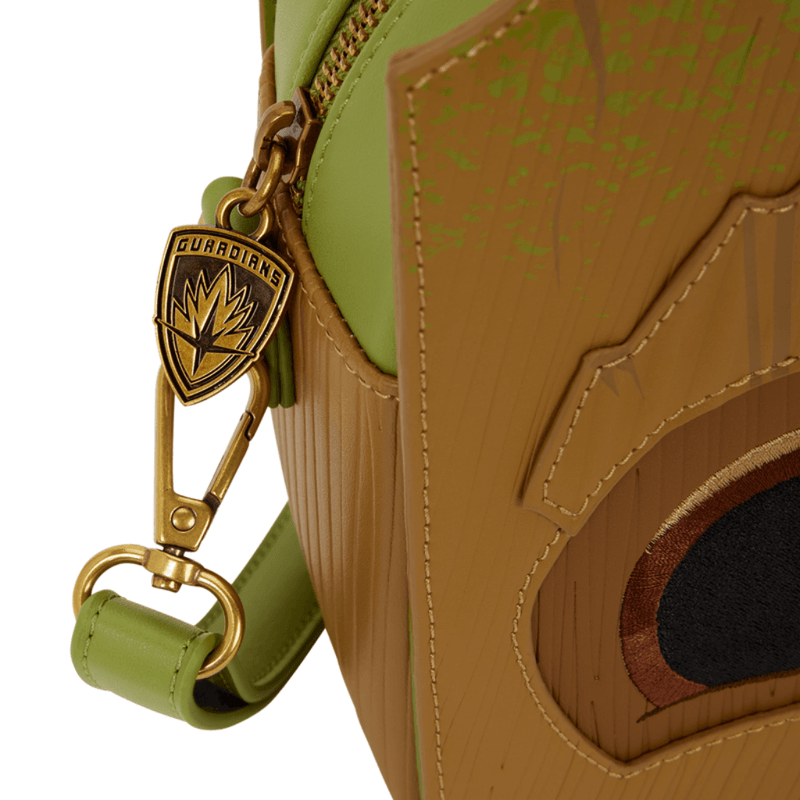 Close-up of gold-tone Guardians of the Galaxy metal charm and textured Groot woodgrain appliqué on Loungefly crossbody bag