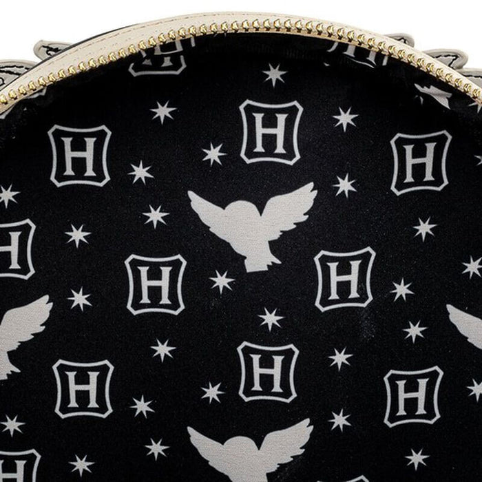 Close-up detail of the Loungefly Harry Potter Hedwig Howler Cosplay Mini Backpack with white Hedwig silhouettes, stars and H icons on a black background