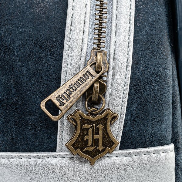 Close-up of antique gold Loungefly zip pull with Hogwarts crest on Hogwarts Castle mini backpack
