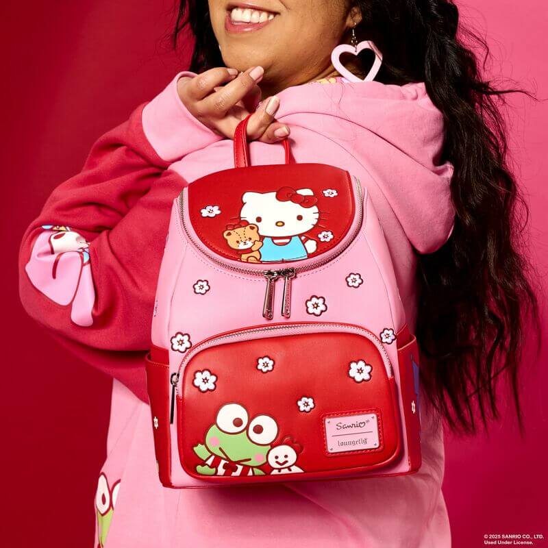 Model wearing pink Loungefly Hello Kitty colourblock mini backpack; front flap shows Hello Kitty and blossom motifs – Loungefly backpack

