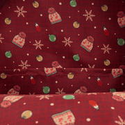 Printed lining of Loungefly Home Alone backpack with hats, baubles and snowflakes on red.