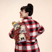 Model wearing Loungefly Home Alone Wet Bandits mini backpack on back, side view.