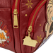 Close-up of gold house zip charm and snowflake detail on red Loungefly Home Alone backpack.