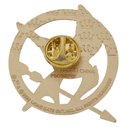 Back of gold-tone Hunger Games Mockingjay enamel pin showing fastening and official licensing markings