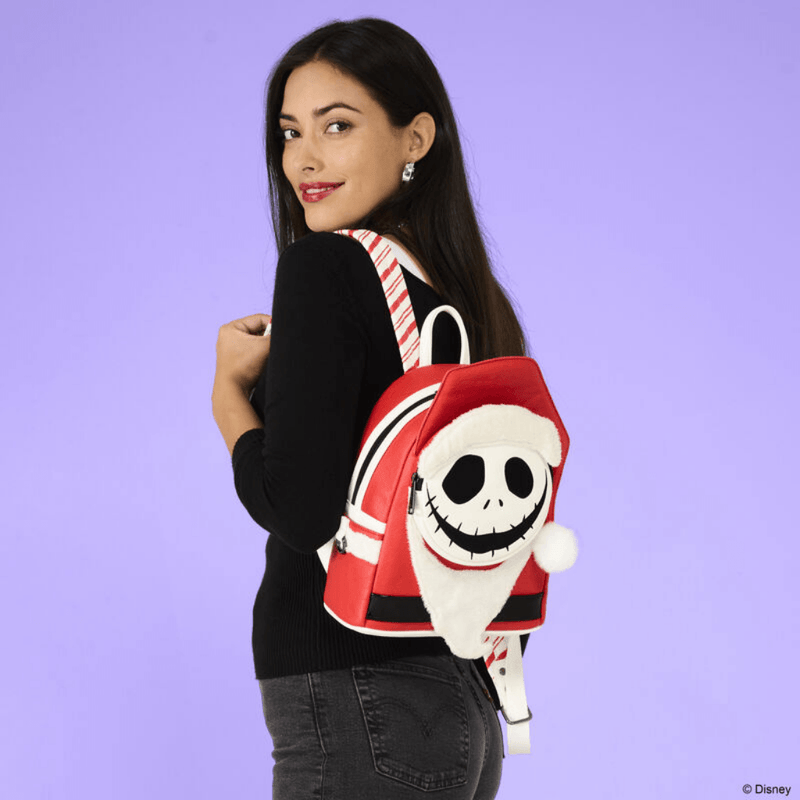 Model wearing the Loungefly Nightmare Before Christmas Jack Skellington Sandy Claws Mini Backpack with plush Santa hat and beard
