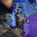 Close-up of Loungefly K-Pop Demon Hunters mystery mini backpack keychain charms attached to a backpack