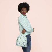 Lifestyle image of the Loungefly Disney Lilo & Stitch Animal Friends All-Over Print Mini Backpack being carried by a model