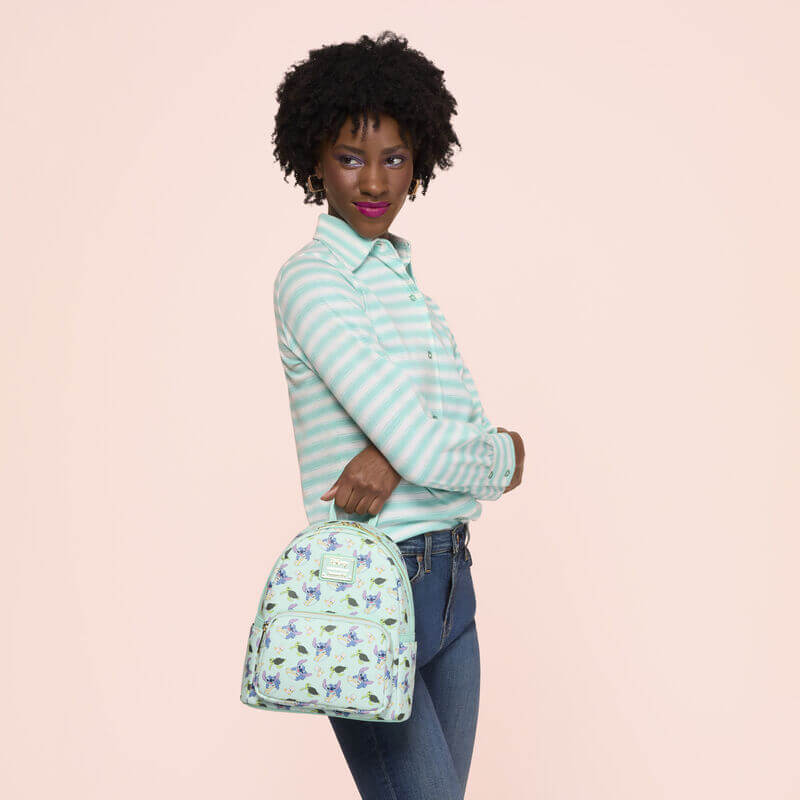 Lifestyle image of the Loungefly Disney Lilo & Stitch Animal Friends All-Over Print Mini Backpack being carried by a model