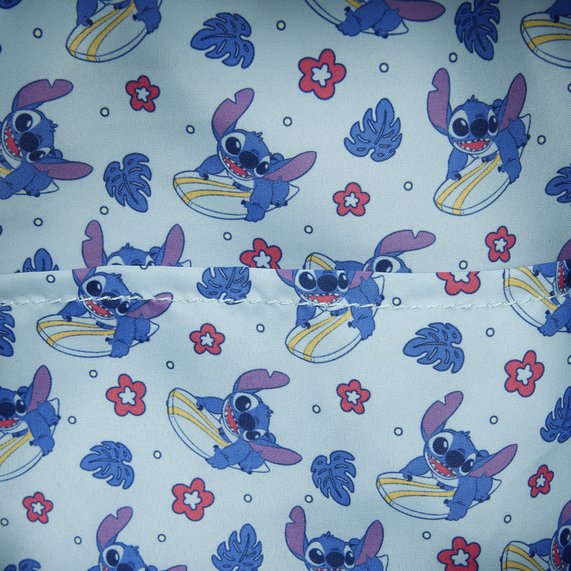 Close-up of the lining inside the Loungefly Disney Lilo & Stitch Animal Friends All-Over Print Mini Backpack with Stitch surfing, tropical leaves and flowers