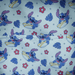 Close-up of the lining inside the Loungefly Disney Lilo & Stitch Animal Friends All-Over Print Mini Backpack with Stitch surfing, tropical leaves and flowers
