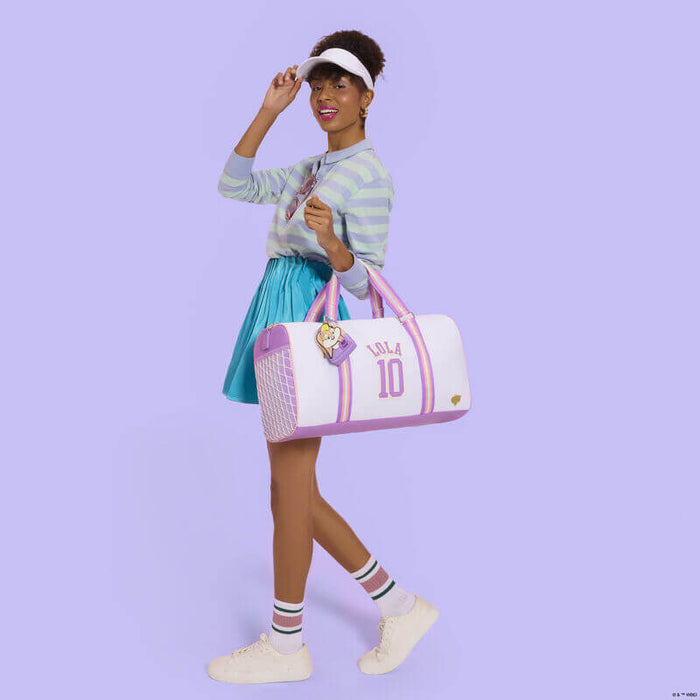 Model using Loungefly Looney Tunes mini backpack keychain as bag accessory