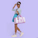 Model using Loungefly Looney Tunes mini backpack keychain as bag accessory